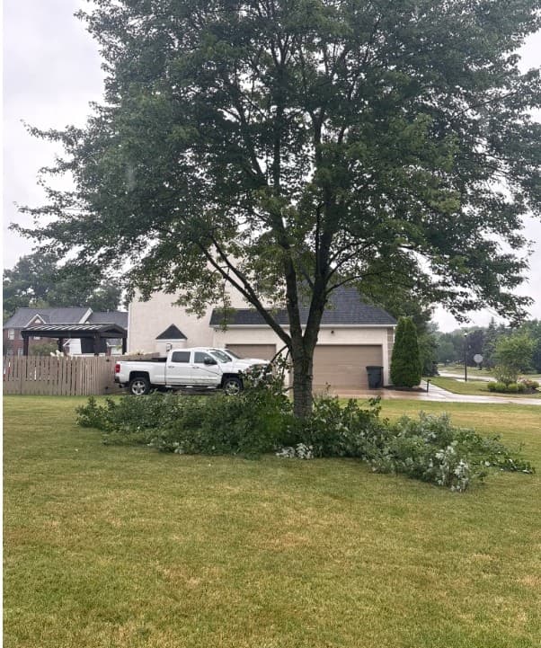 Brush stacked on a lawn beside the truck part way through a job: tree removal by A.S.H. Tree Service, serving Lithopolis, OH